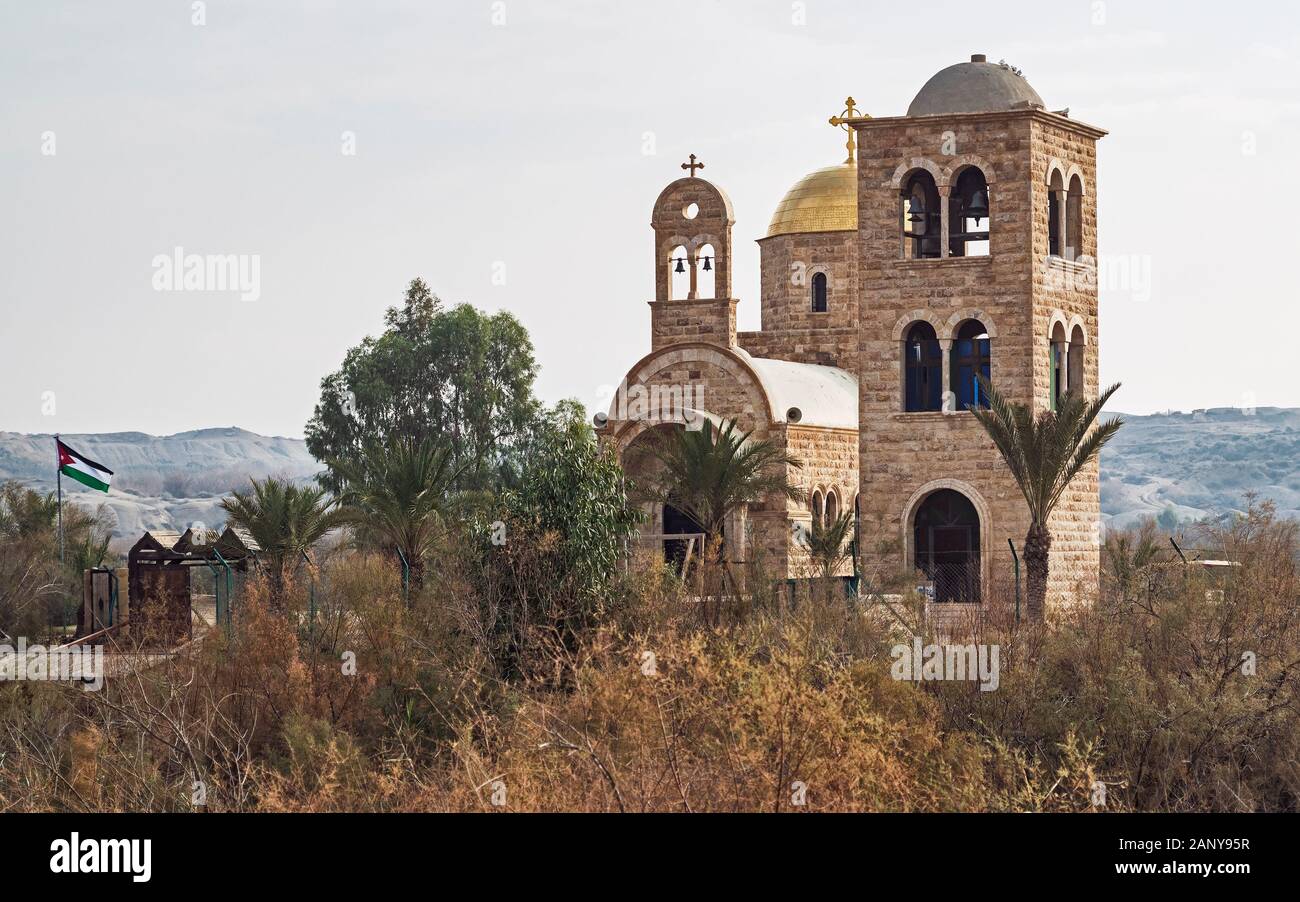 Antico e moderno chiese di pietra nel luogo del battesimo di Gesù nel fiume Giordano visto dalla Cisgiordania Foto Stock