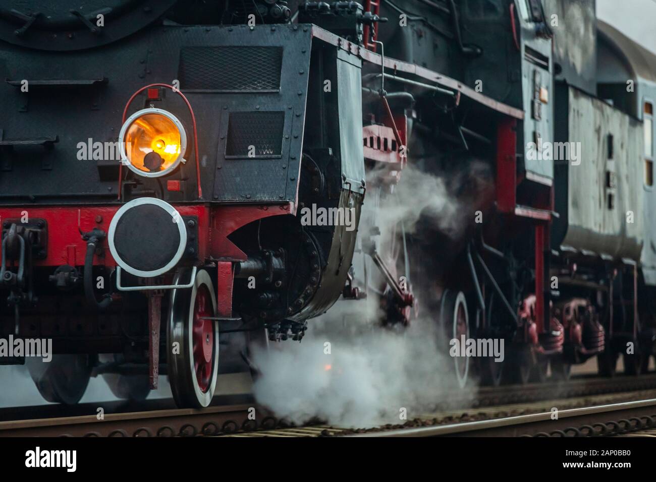 Un vecchio treno a vapore con poche autovetture che corrono su piste moderne. Foto Stock