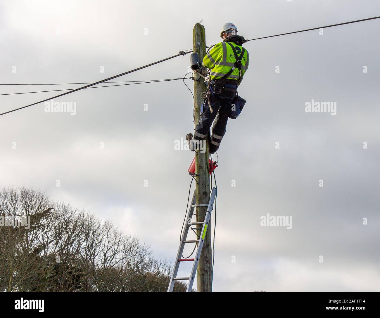 Ingegnere di telefono lavoro in altezza su una linea telefonica Foto Stock