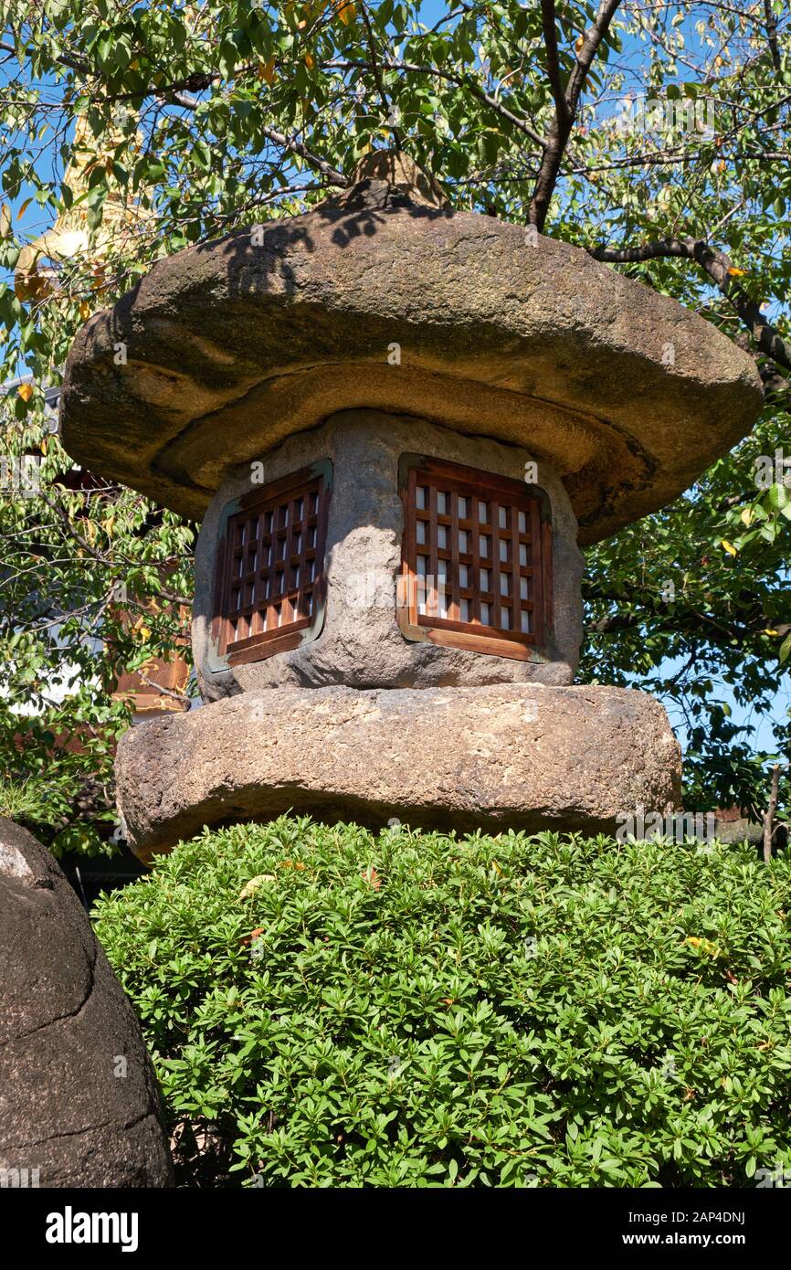 La vista della lanterna di pietra giapponese Nazura-doro fatta con pietre ruvide e non lucidate nel Tempio Isshin-ji di Osaka. Giappone Foto Stock