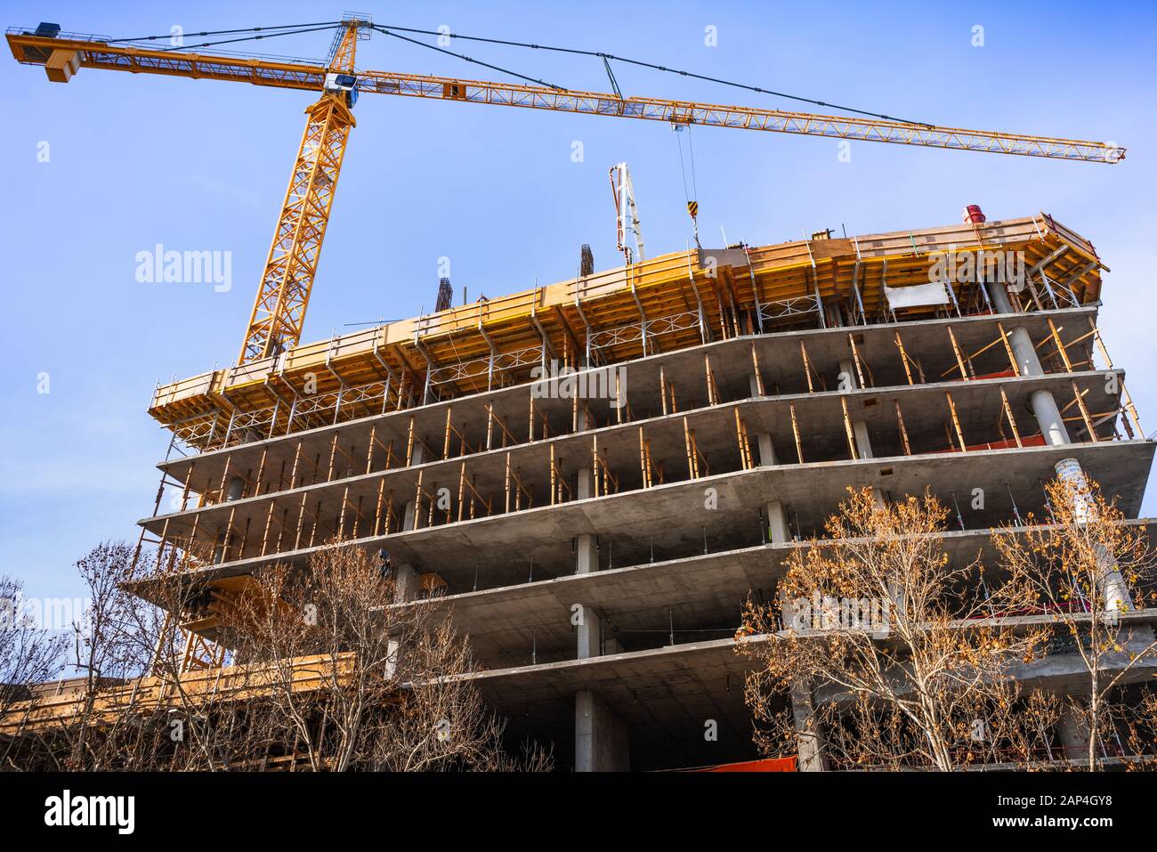 Multi-livello di cemento edificio in costruzione con gru a torre; nuovo sviluppo residenziale nel cuore di Silicon Valley, San Jose, California Foto Stock