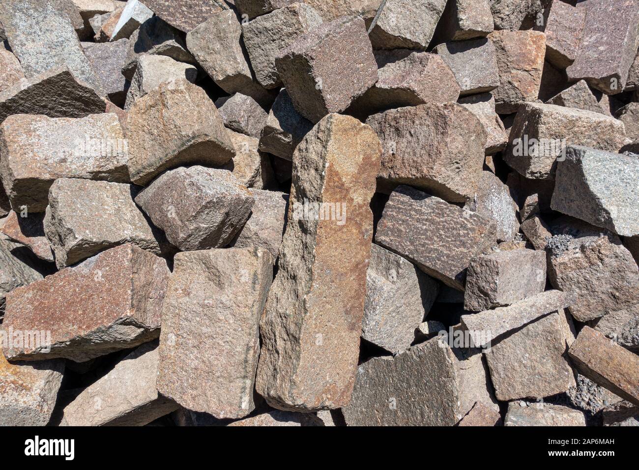 Pietre di pavimentazione di granito ruvide e rotte in un mucchio Foto Stock