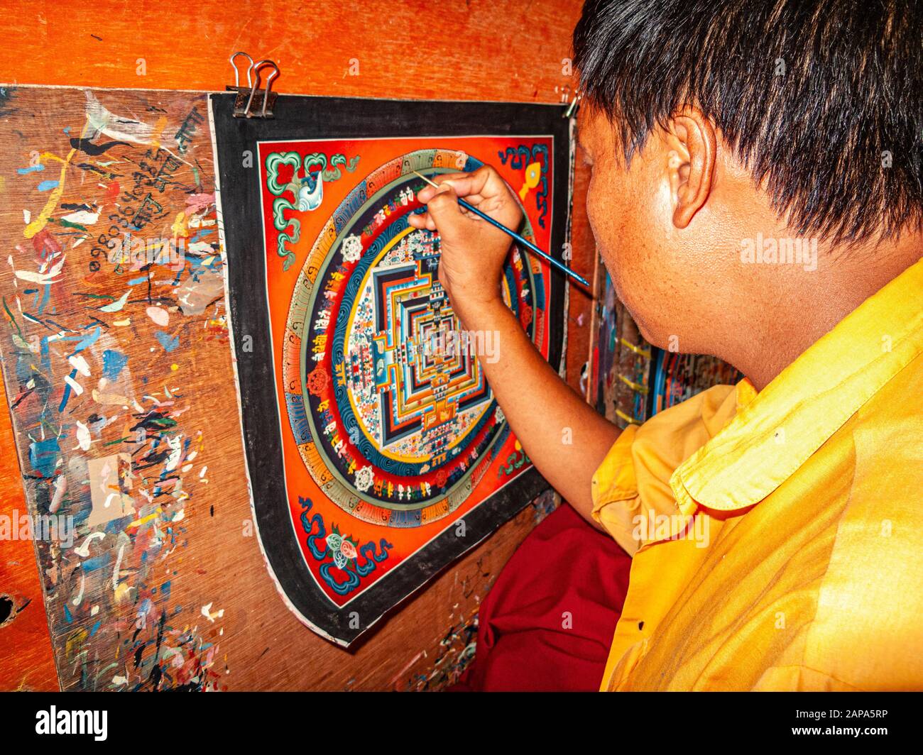 Un artista sta dipingendo una Tangka colorata Foto Stock