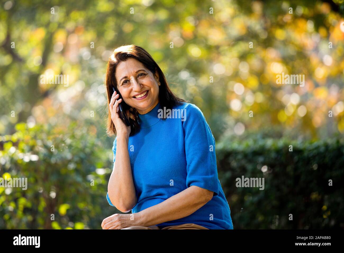 Messaggistica di testo Happy Senior Woman tramite telefono cellulare Foto Stock