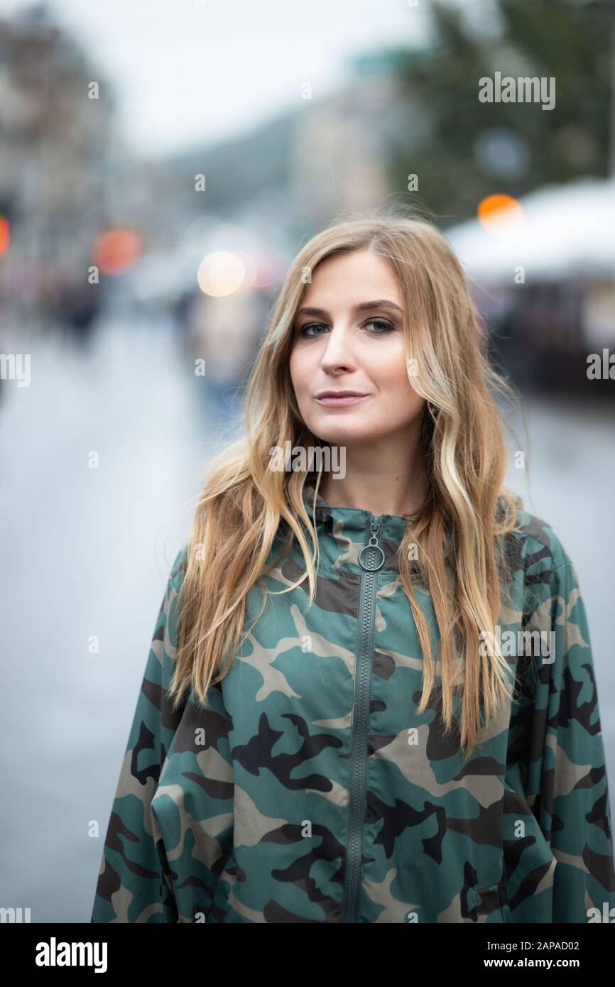 Giovani donne in giacca camouflage posa sulla strada della città Foto Stock