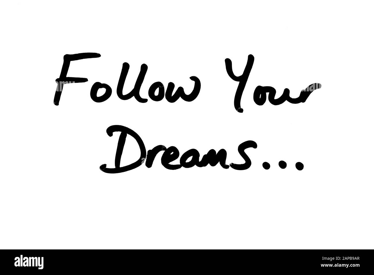 Segui I tuoi sogni… scritti a mano su uno sfondo bianco. Foto Stock