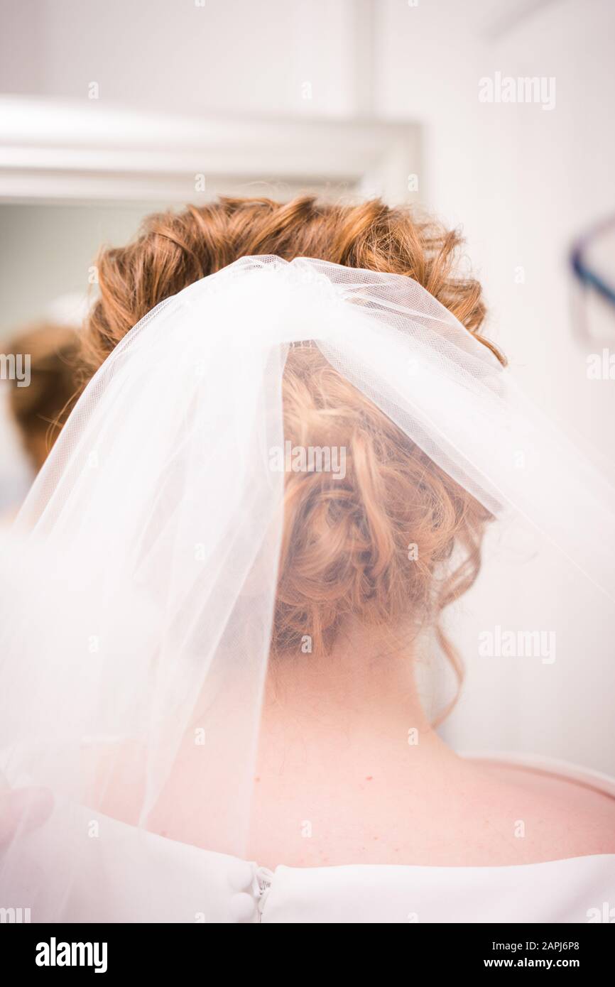 Bianco velo nuziale in capelli della sposa fatta in su prima della cerimonia Foto Stock