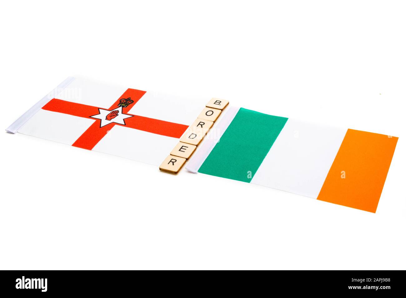 La bandiera nazionale dell'Irlanda del Nord e della Repubblica d'Irlanda su sfondo bianco con Un Cartello che legge La Frontiera Foto Stock