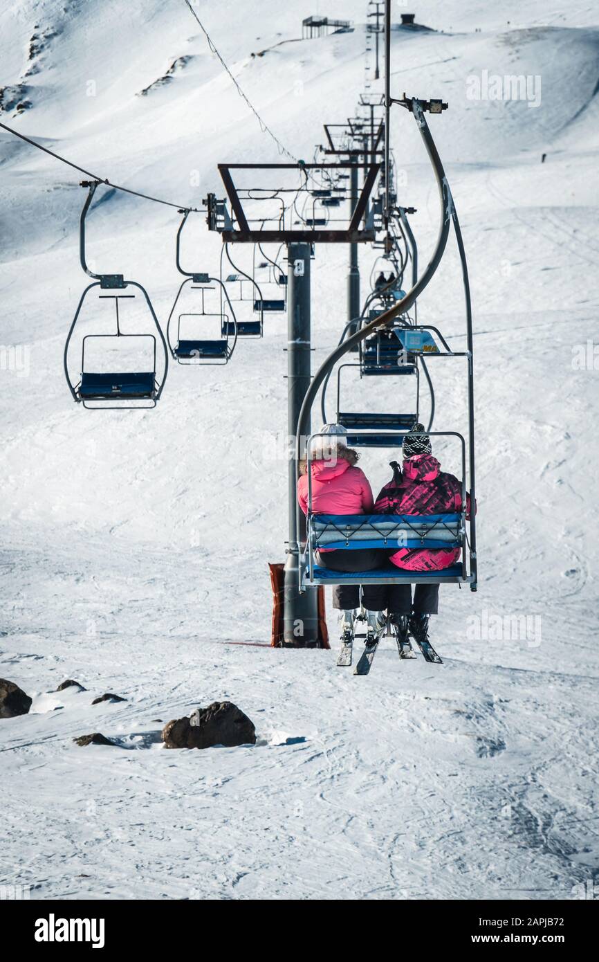 Una coppia su uno skilift vista da dietro in Francia Foto Stock