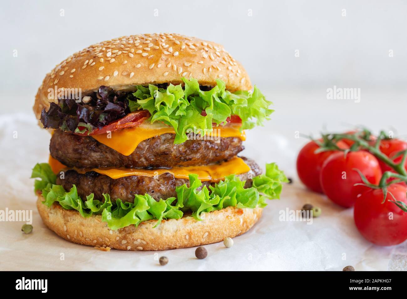 Grande cheeseburger primo piano sul tavolo. Foto Stock
