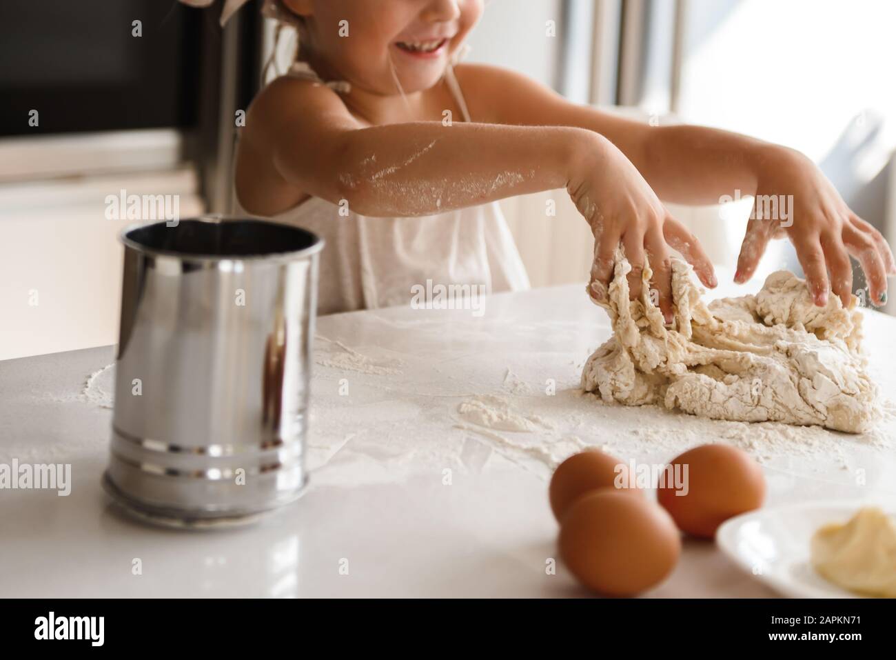 Bambina che cucina la pizza in cucina Foto Stock