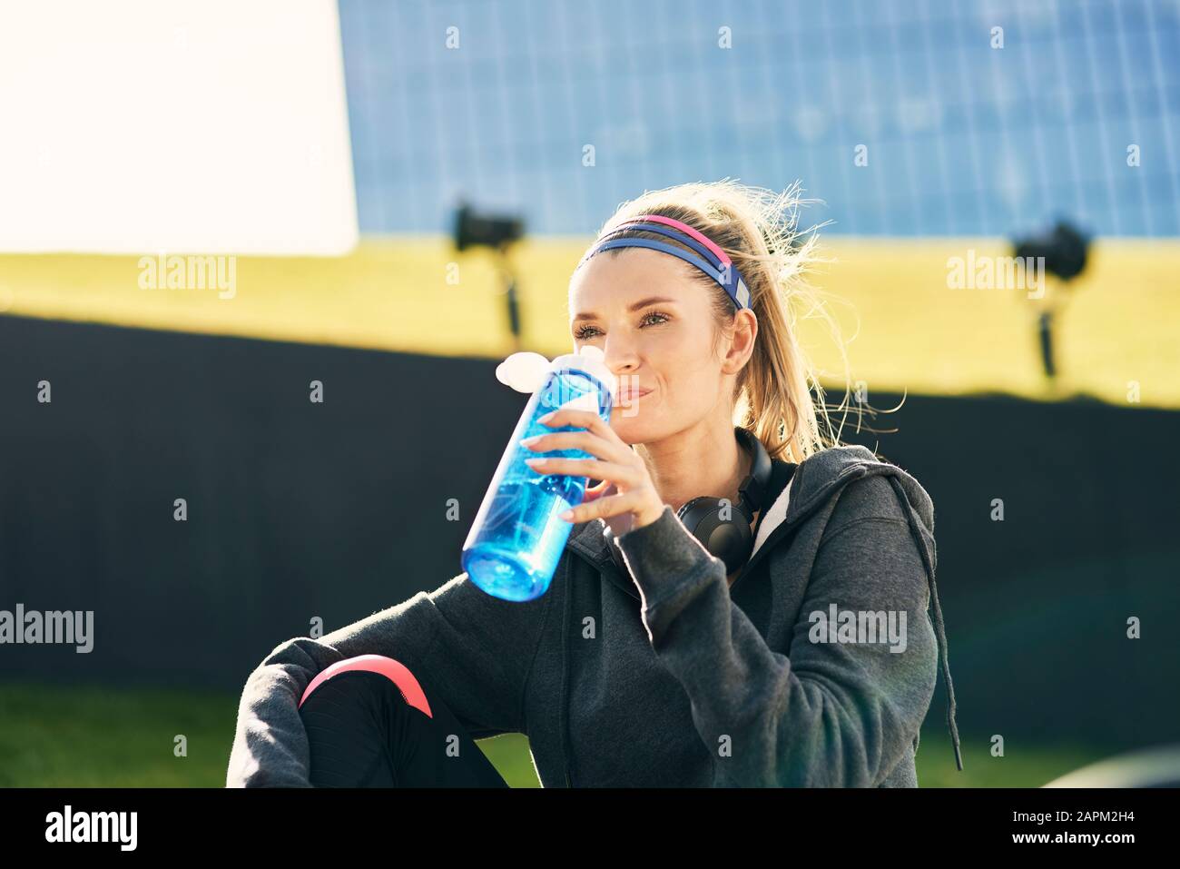 Donna bere acqua dopo duro allenamento Foto Stock