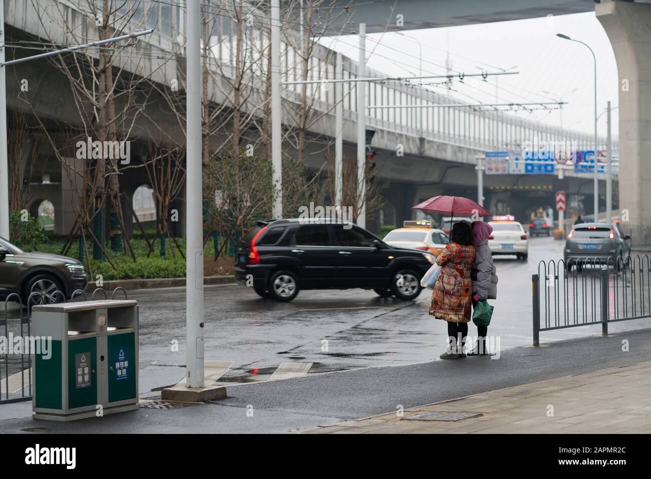 Wuhan China , 24 gennaio 2020 : Persone in strada con ombrello durante il secondo giorno del blocco della città per prevenire l'epidemia di coronavirus a Wu Foto Stock