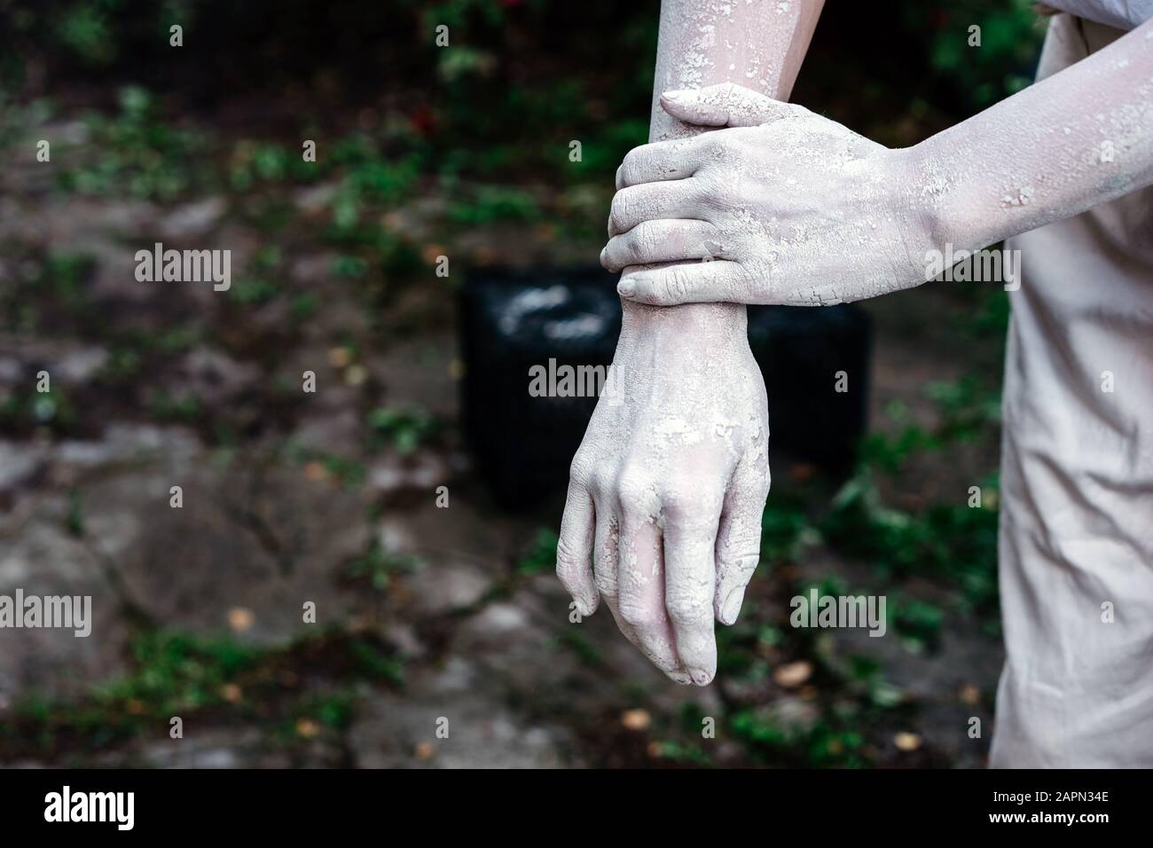 Una coppia di eleganti mani femminili in creta asciugata su sfondo bianco Foto Stock