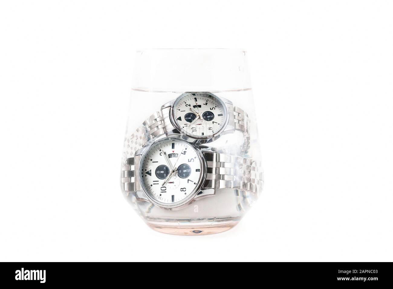 Impermeabile, quadrante bianco, cinturino in argento, forma rotonda uomo e donna orologi da polso classici immersi in vetro di acqua isolato su sfondo bianco. Foto Stock Impermeabile, quadrante bianco, cinturino in argento, forma rotonda uomo e donna orologi da polso classici immersi in vetro di acqua isolato su sfondo bianco. Foto Stock