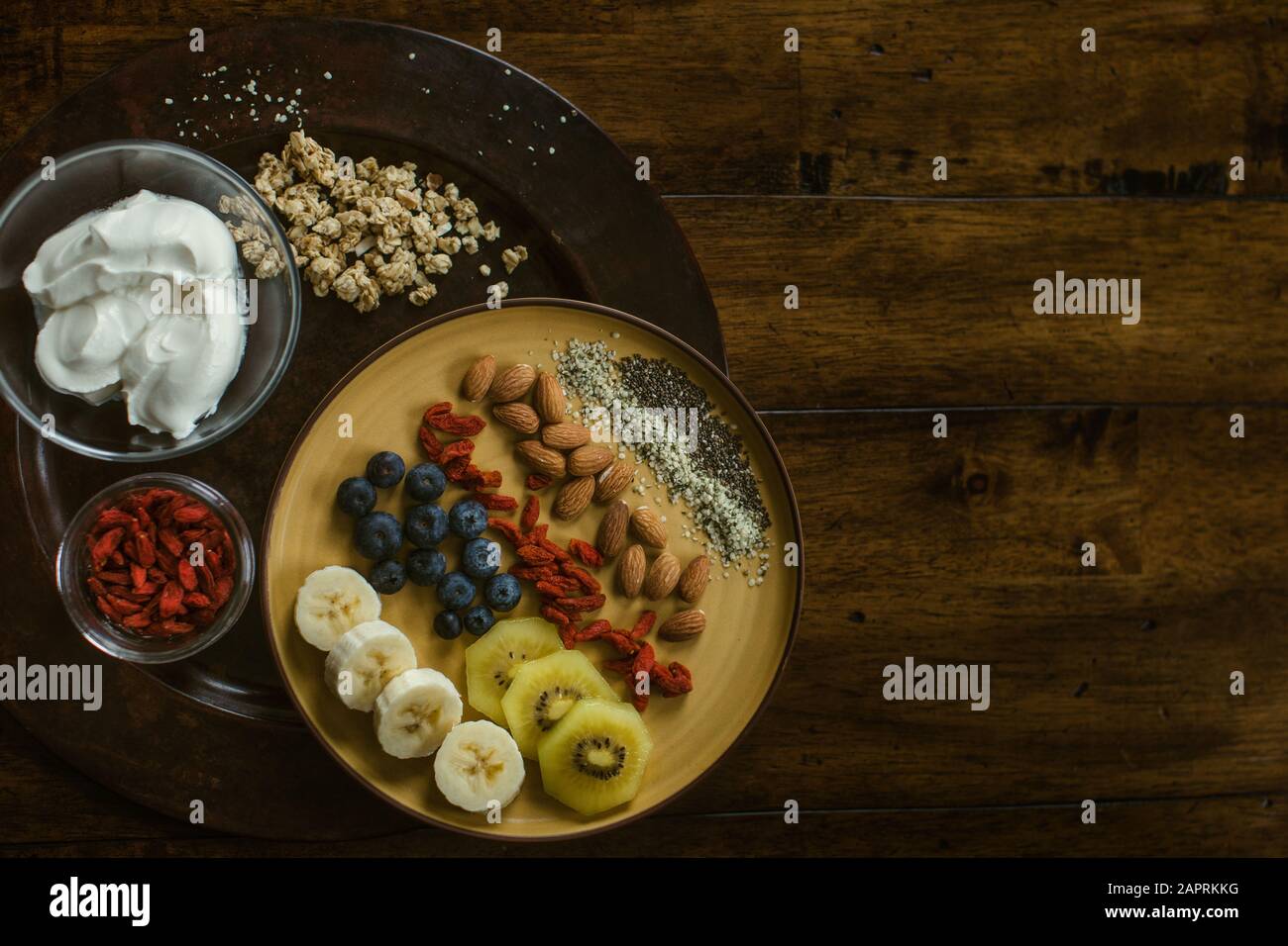 Piatto di frutta, noci e semi salutari e deliziosi con yogurt e frutti di bosco di gogi Foto Stock