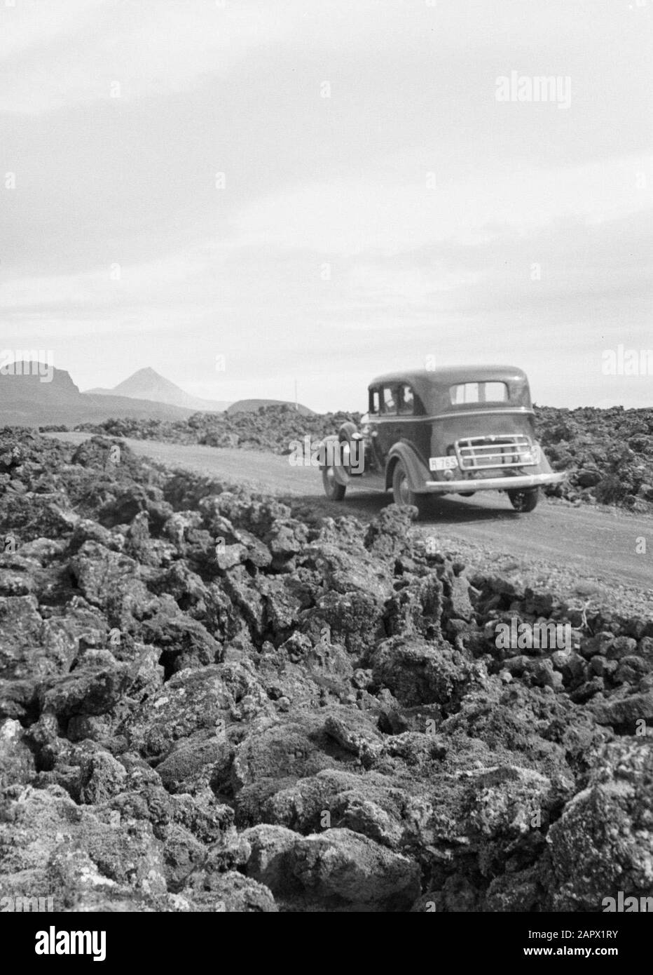 Islanda Passenger car on a Road through a Volcanic landscape Data: 1934 Località: Islanda Parole Chiave: Automobili, vulcani, strade Nome personale: Saxfon Foto Stock