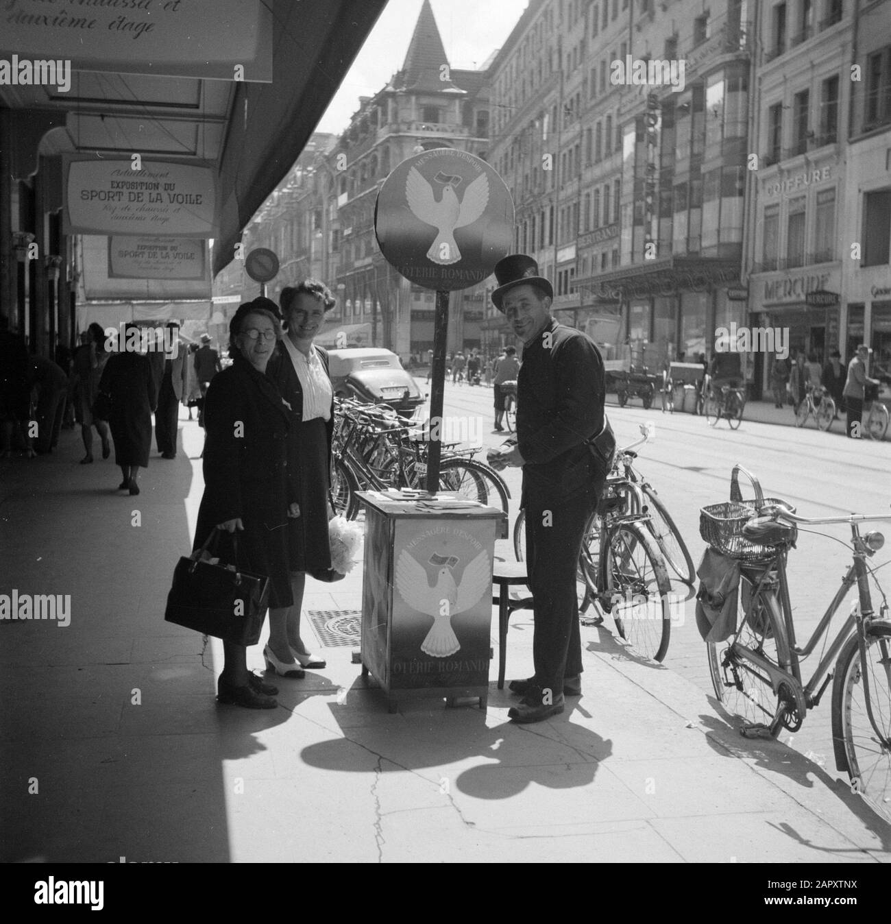 Venditore di biglietti della lotteria per Il Passaggio di costruzione a Ginevra? Con un Exposition du Sport de la Voile Data: 1946 luogo: Ginevra, Svizzera Parole Chiave: Lotteries, immagini di strada Foto Stock