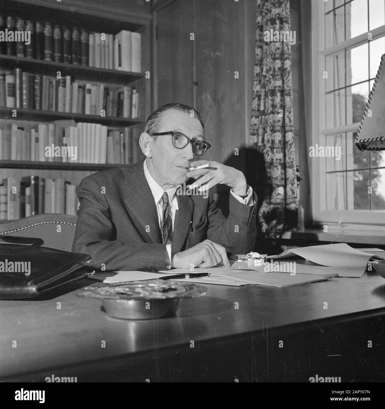 Visiting in Inking Walter Mehring Smoking Behind a desk Data: Giugno 1964 luogo: Germania, Monaco di Baviera, Germania occidentale Parole Chiave: Libri, interni, mobili, fumo, scrittori, borse, case Nome personale: Mehring, Walter Foto Stock