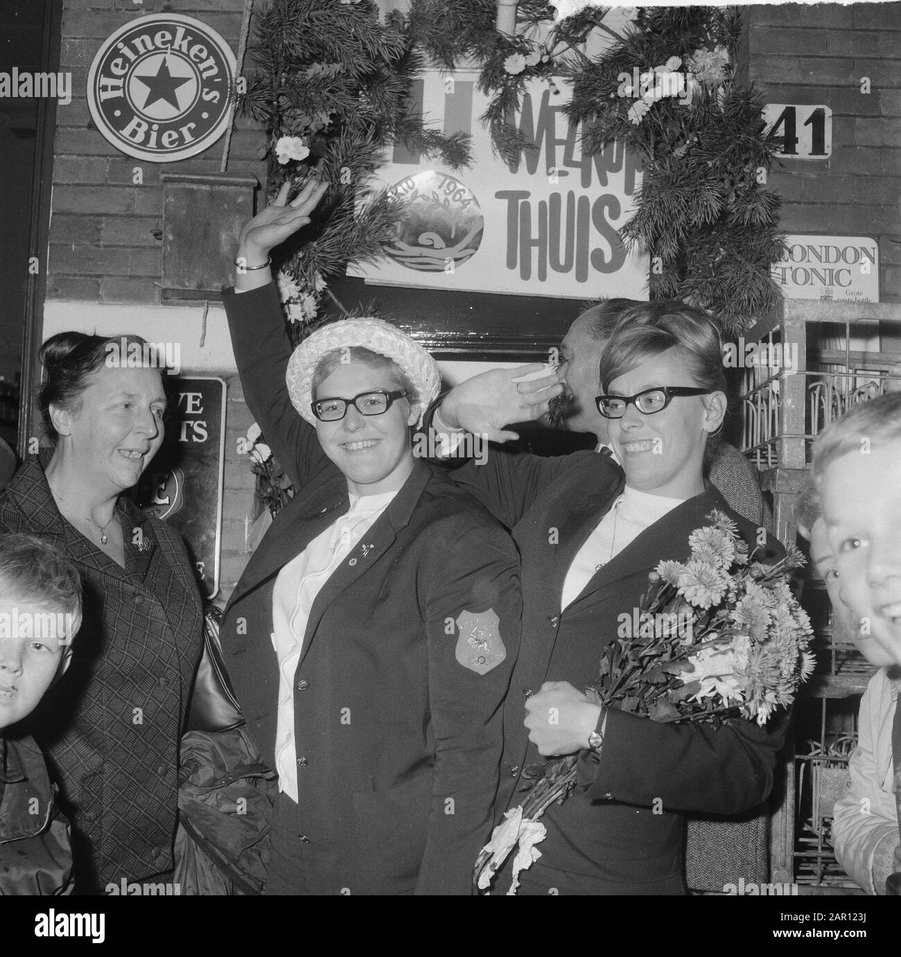 Squadra olimpica olandese ritorno arrivo Schiphol, sinistra Gretha Kok e destra Ada Kok sono stati presi in su alla loro casa su Amsteldijk Data: 25 ottobre 1964 luogo: Noord-Holland, Schiphol Parole Chiave: Arrivi, case, squadre Nome personale: Gretha Kok, Kok, Ada Foto Stock