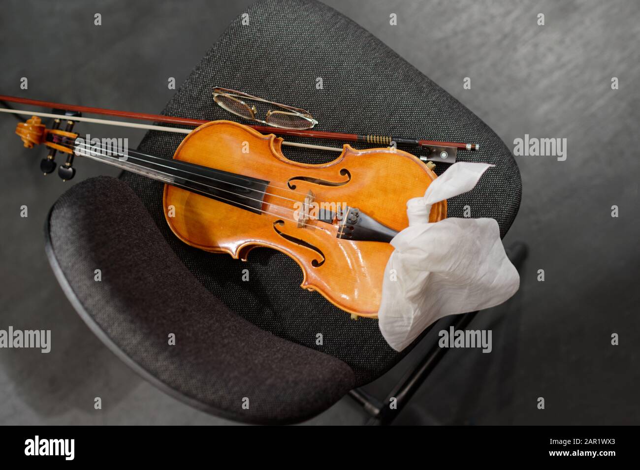 Strumenti musicali: Violino e arco sulla sedia del musicista Foto Stock
