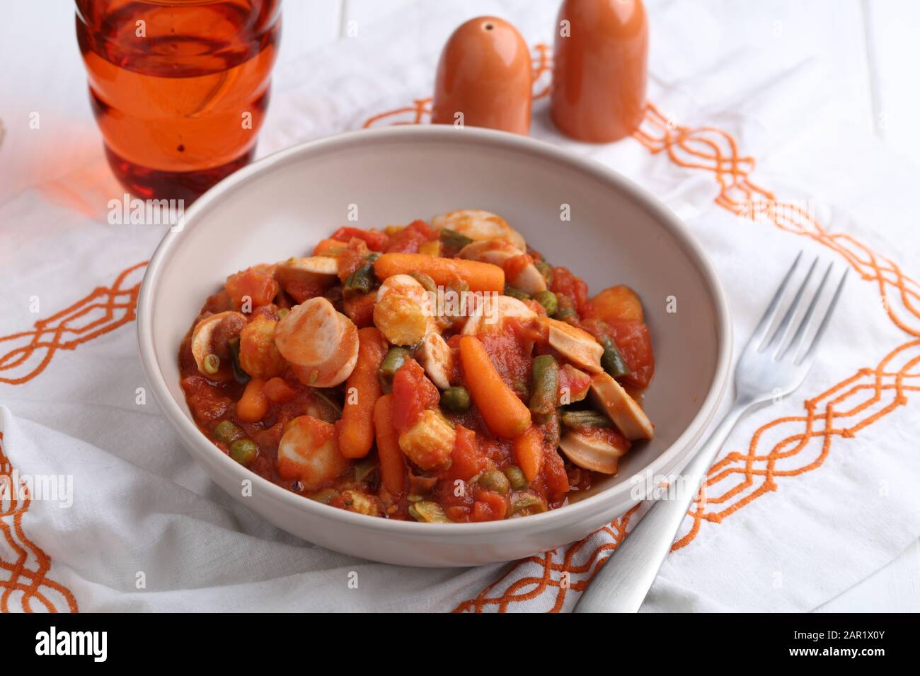 Salsiccia di pollo e ragù di verdure con carota, mais, fagiolo verde, pepe, pisello verde e salsa di pomodoro Foto Stock