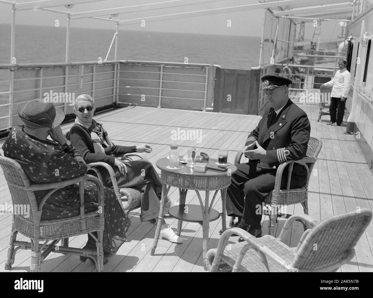 Viaggio in mare con la signora Baloeran Captain Dubois sul ponte con due donne tra cui la moglie del sultano di Johor (Malesia) Annotazione: Questa foto fa parte di una serie di foto di un viaggio con la MS Baloeran van de Rotterdam Lloyd Data: 1935 Parole Chiave: Capitani, navi Nome personale: Dubois, A.. Foto Stock