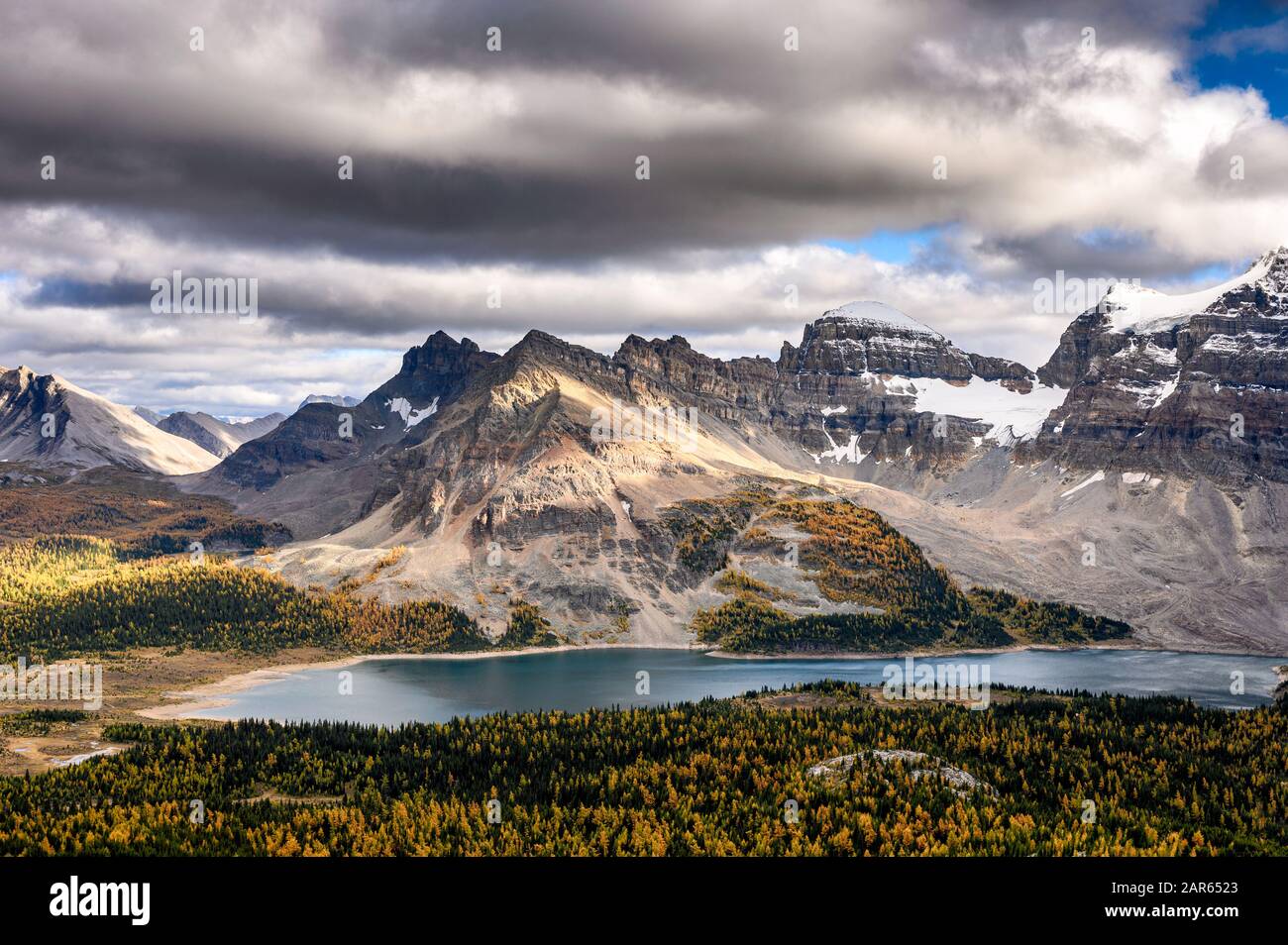 Montagne rocciose con luce del sole e lago sulla tuggiosa al parco provinciale di Assiniboine, British Columbia, Canada Foto Stock
