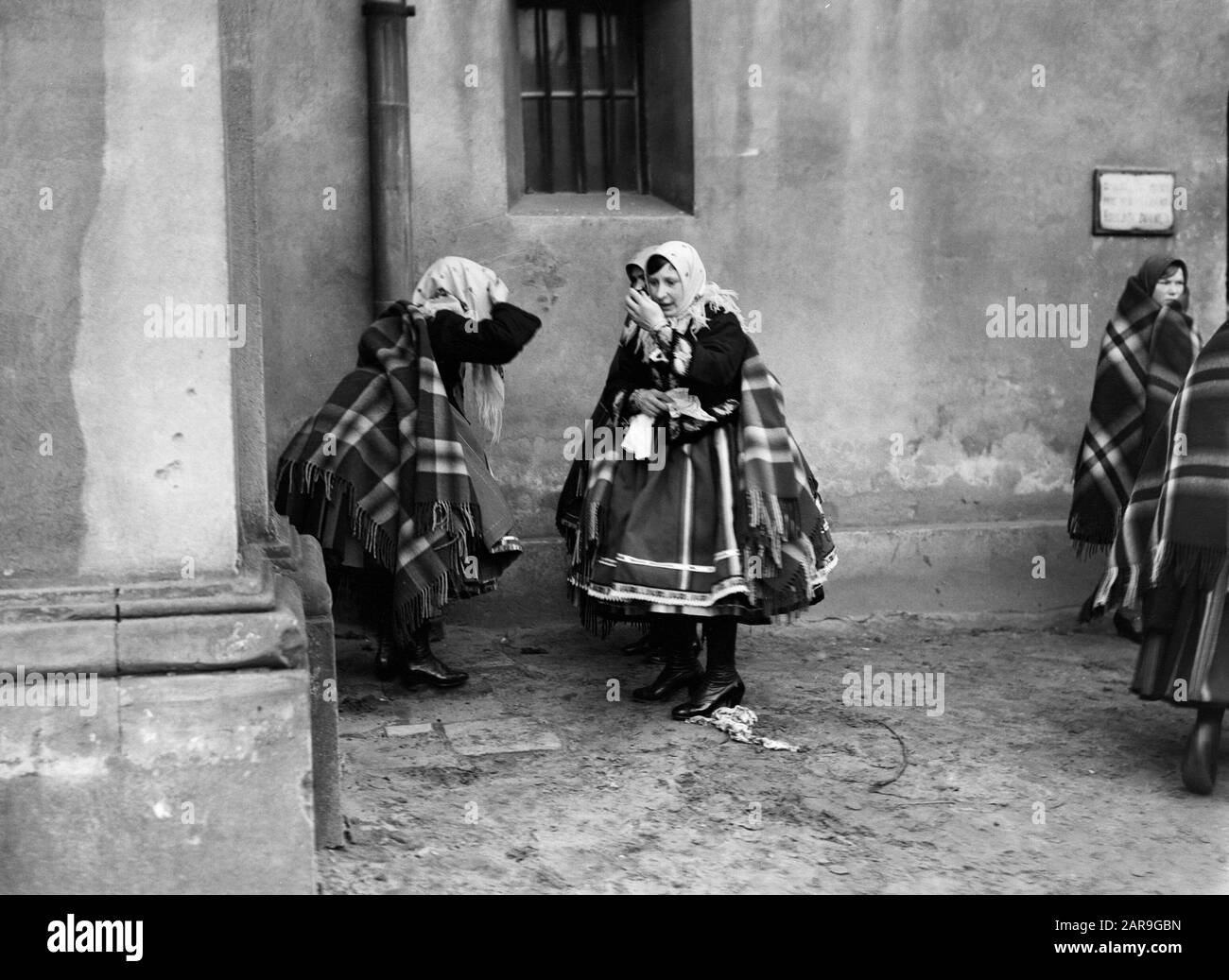 Viaggio in Polonia Donne a Lowicz si guarda nello specchio prima di entrare nella chiesa Data: 1934 posizione: Polonia Parole Chiave: Chiesa edifici, costume, cultura popolare Foto Stock