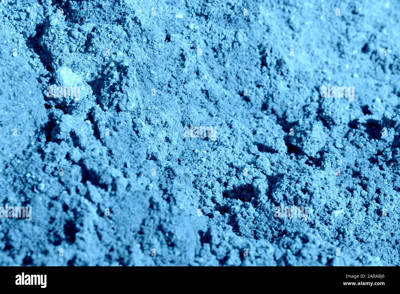 Costruzione sabbia texture primo piano. Naturale astratto sfondo blu colore tonato Foto Stock