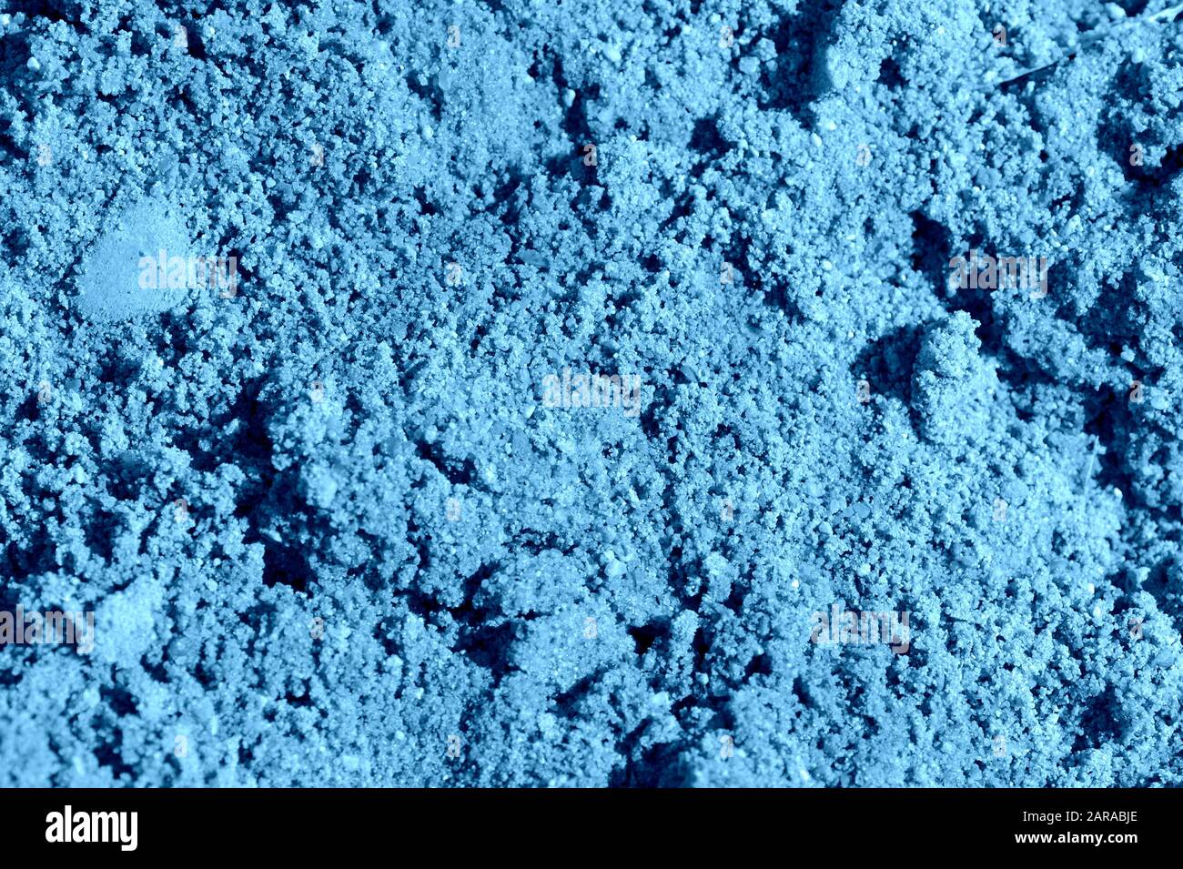Costruzione sabbia texture primo piano. Naturale astratto sfondo blu colore tonato Foto Stock