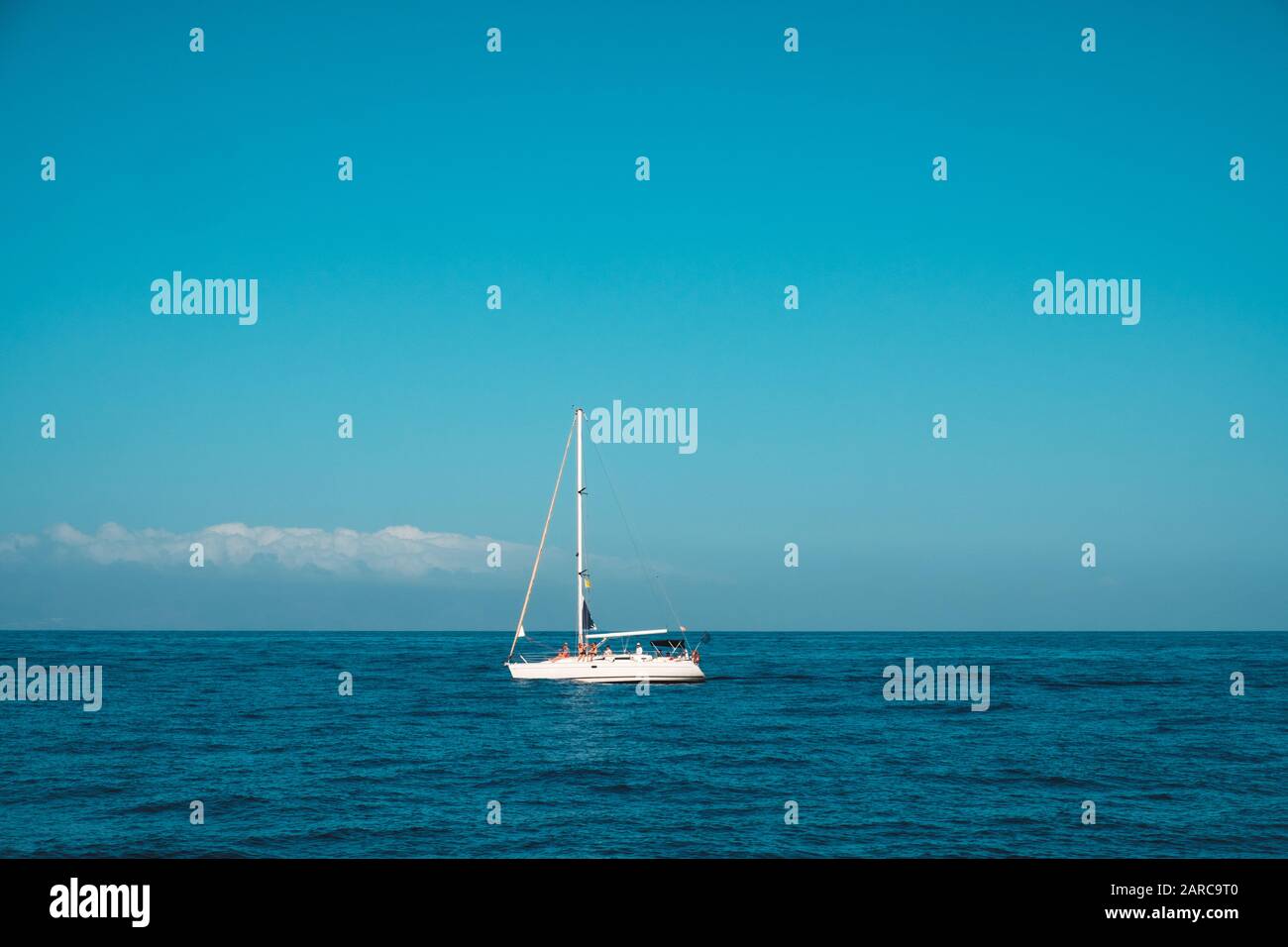 persone in barca a vela sull'oceano, barca a vela all'orizzonte Foto Stock