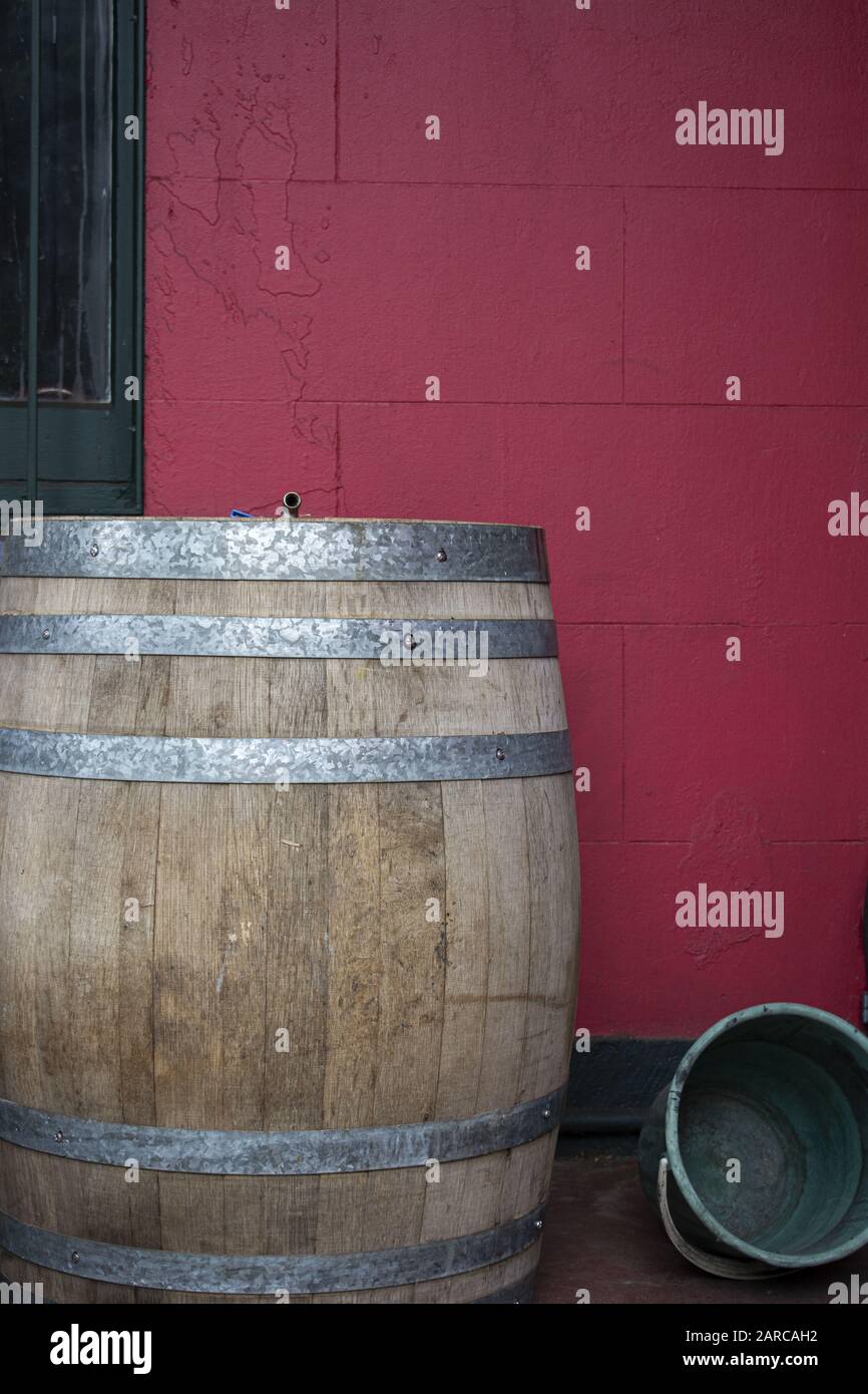 Colpo verticale di un barile di legno davanti a un parete rosa Foto Stock