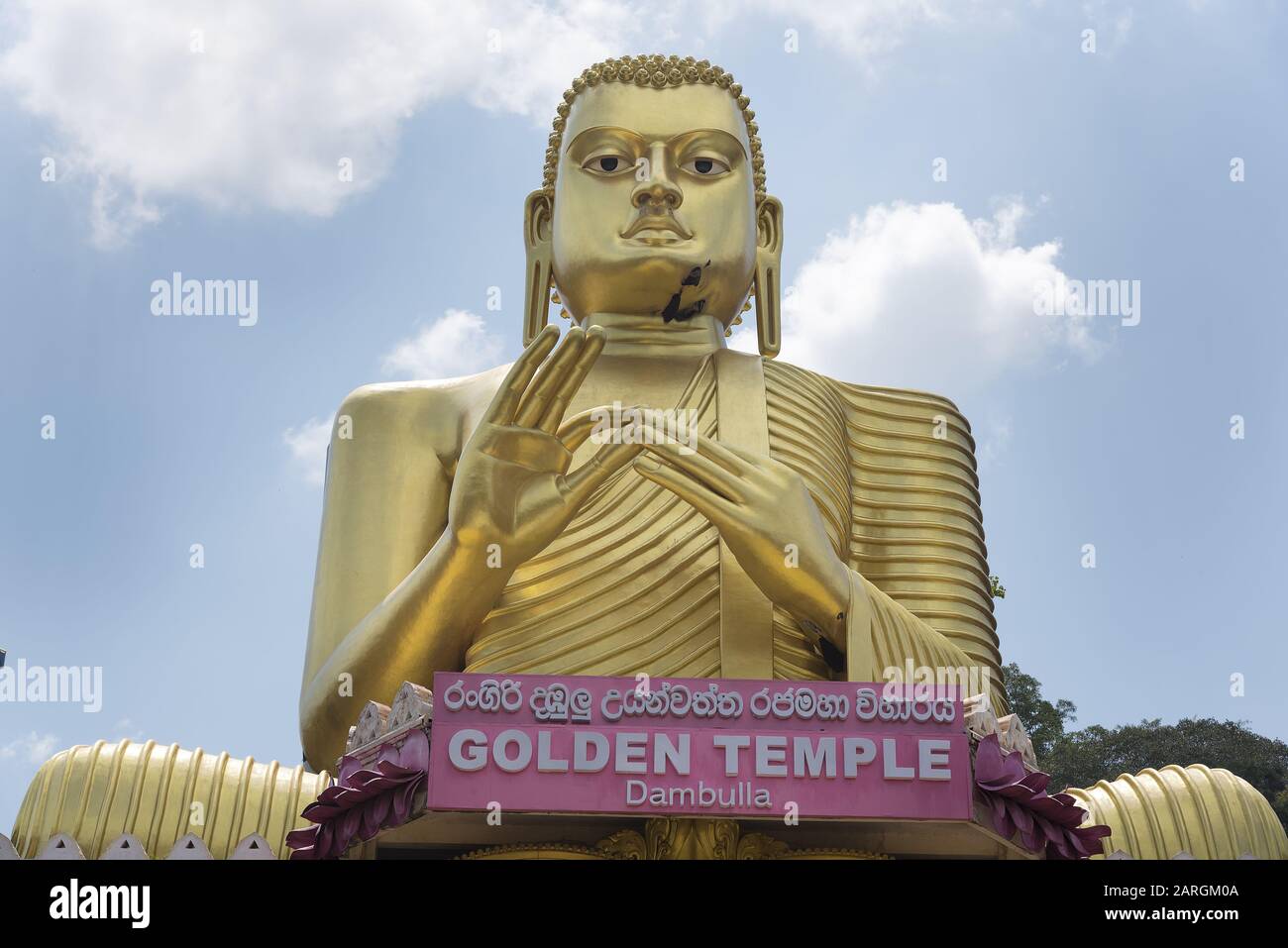 Dambulla, Sri Lanka: La facciata principale del Tempio d'Oro del Museo Buddista che mostra il primo piano della statua del Buddha con il nome del tempio. Mondo Foto Stock