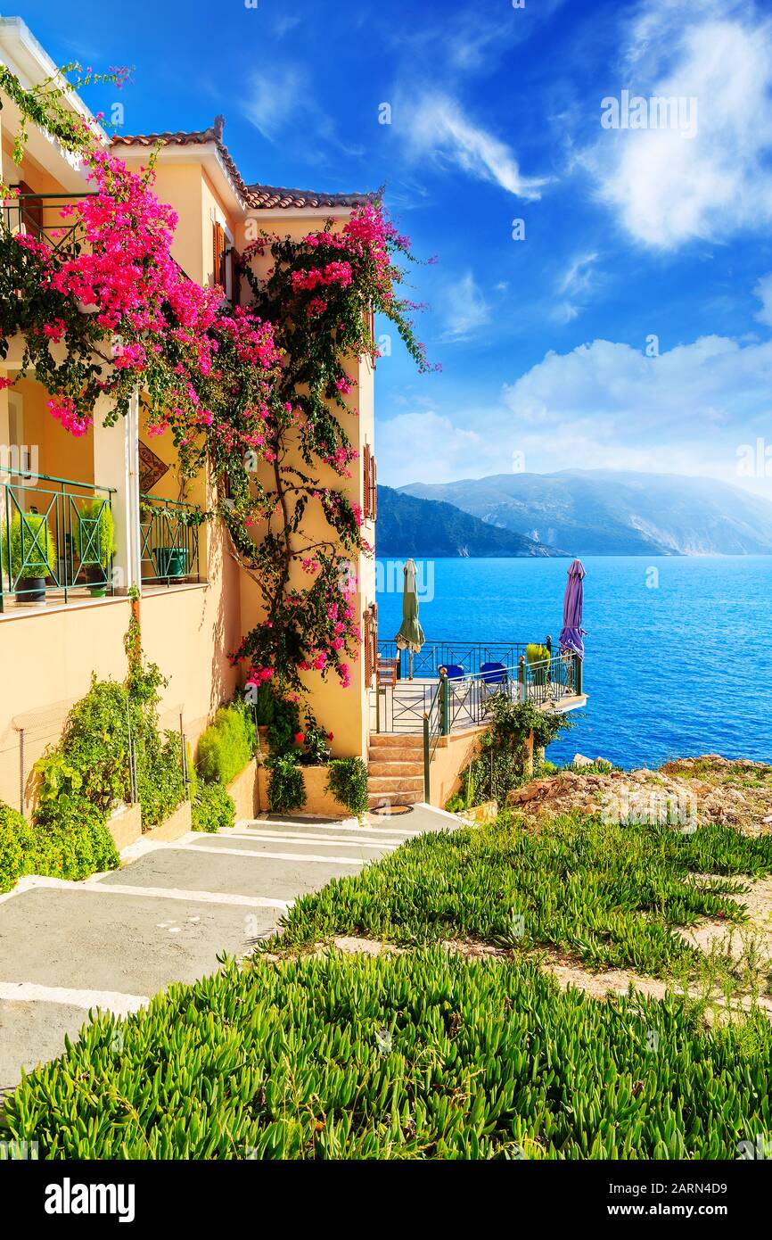 Casa con fiori sulla costa dell'isola di Cefalonia nel villaggio di Assos, Grecia Foto Stock
