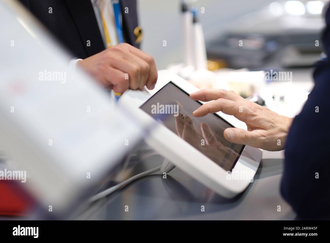 Presentazione delle possibilità di attrezzature mediche all'esposizione tecnologica. Mano maschio sul touchscreen Foto Stock