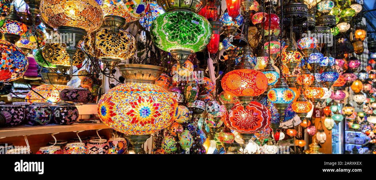 Belle lampade in Gran Bazar, Istanbul, Turchia. Vista panoramica dei colorati doni orientali. Lampade in vetro colorato in primo piano sul mercato artigianale. Arabo e. Foto Stock