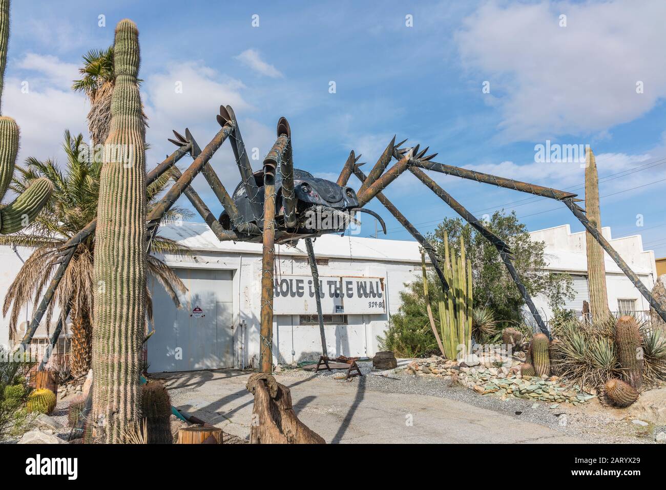Una gigantesca scultura di ragno realizzata con parti saldate, tra cui un Maggiolino Volkswagen, si trova all'esterno di un'azienda lungo Indian Canyon Rd a Palm Springs. Foto Stock