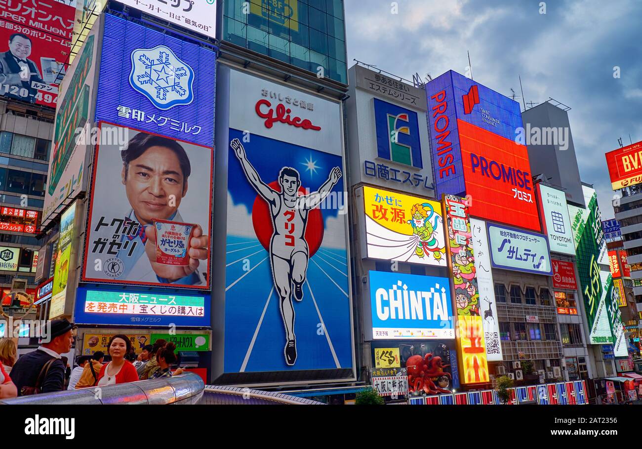 OSAKA, Giappone - 14 ottobre 2019: La luminosa e appariscente cartelloni lungo il canale Dotonbori con il simbolo della città, il Glico uomo che corre a nig Foto Stock