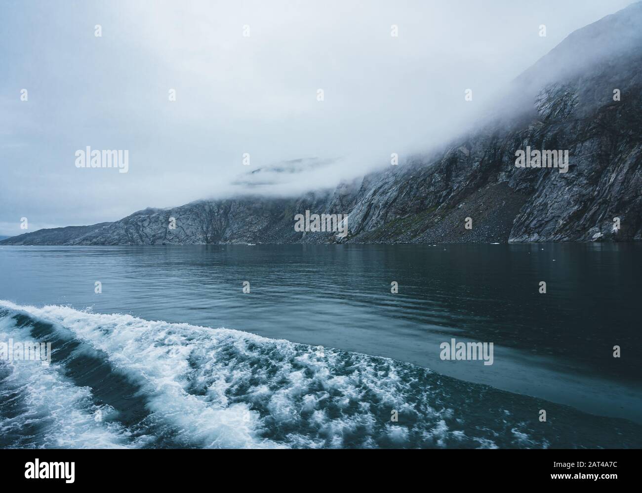 Onde che si infrangono sulla riva su un nuvoloso giorno nel circolo polare artico in Groenlandia. Potente oceano onde rompere.Wave si rompe su una banca poco profonde. Natural Foto Stock