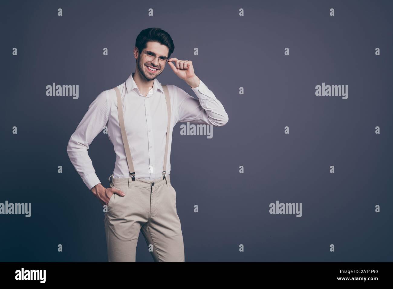 Foto di bel sicuro business uomo affascinante sorriso responsabile giovane  capo vestito formalwear camicia bianca beige bretelle pantaloni specifiche  isolato Foto stock - Alamy