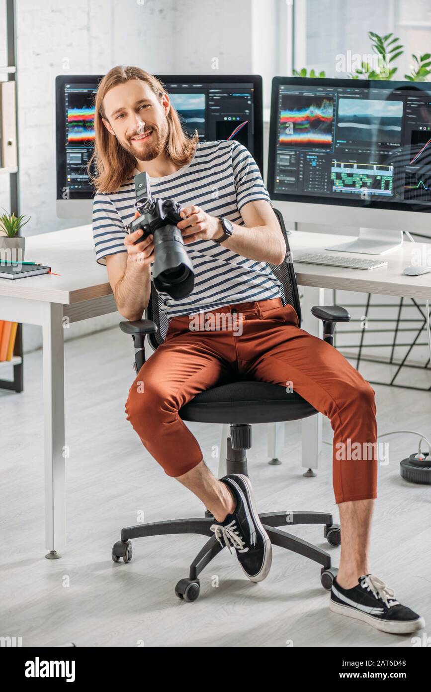buon e bearded art editor con fotocamera digitale Foto Stock