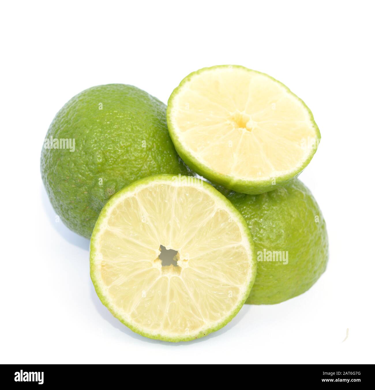 Lime intero e tritato su bianco Foto Stock