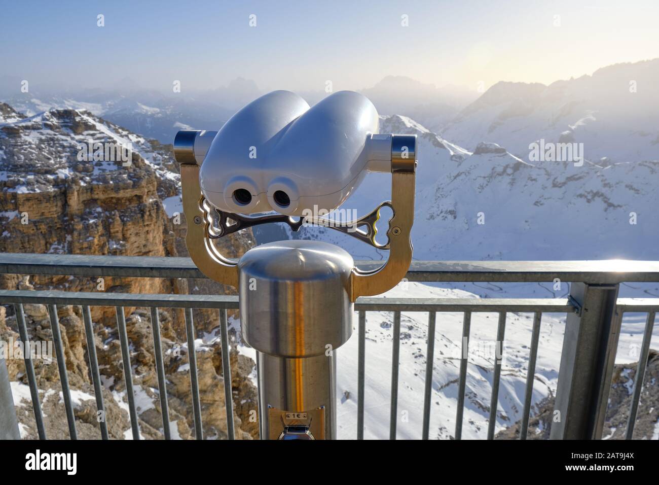 Binocolo a gettoni posto in alto sopra il passo di Pordoi in Italia, si affaccia su un bellissimo panorama di montagna invernale nelle Dolomiti su una brigata Foto Stock