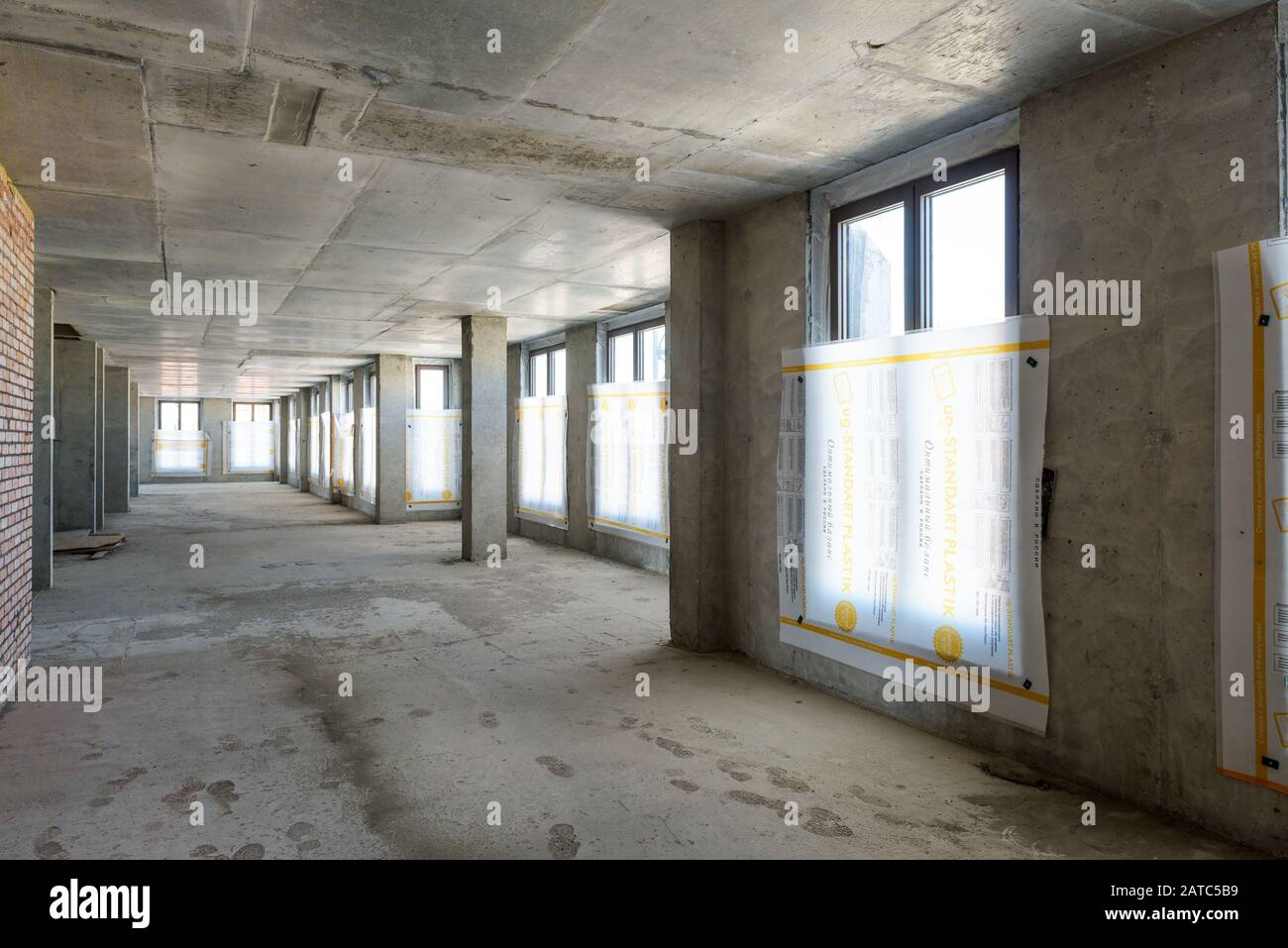 Mosca - 10 agosto 2017: All'interno della struttura in costruzione con pareti in cemento, soffitto e pavimento. Vista panoramica del corridoio del cantiere Foto Stock