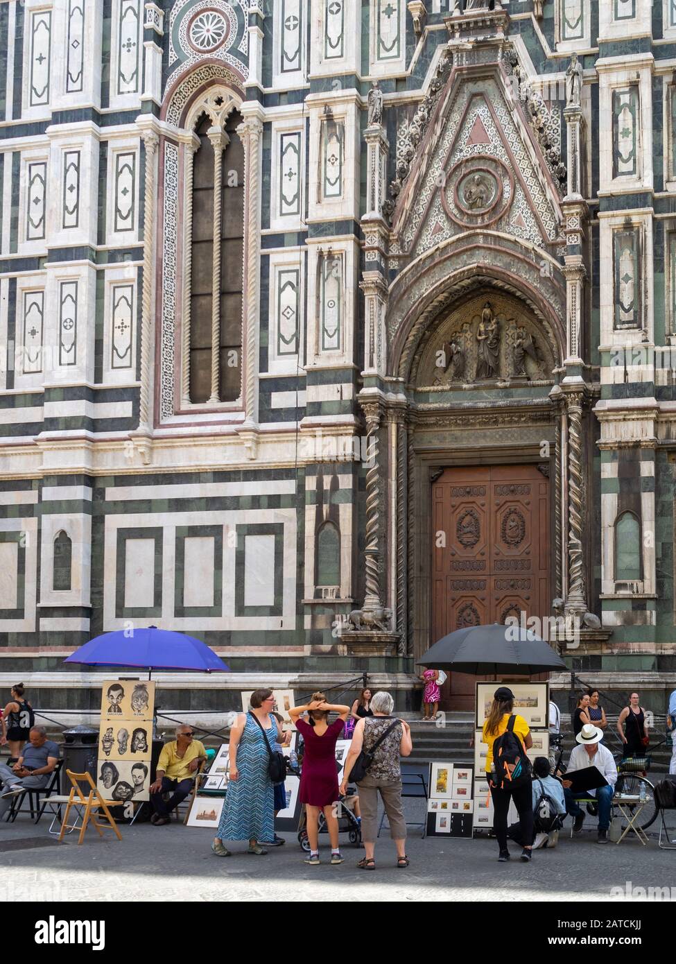 Artisti di strada disegnano ritratti turistici del Duomo di Firenze Foto Stock