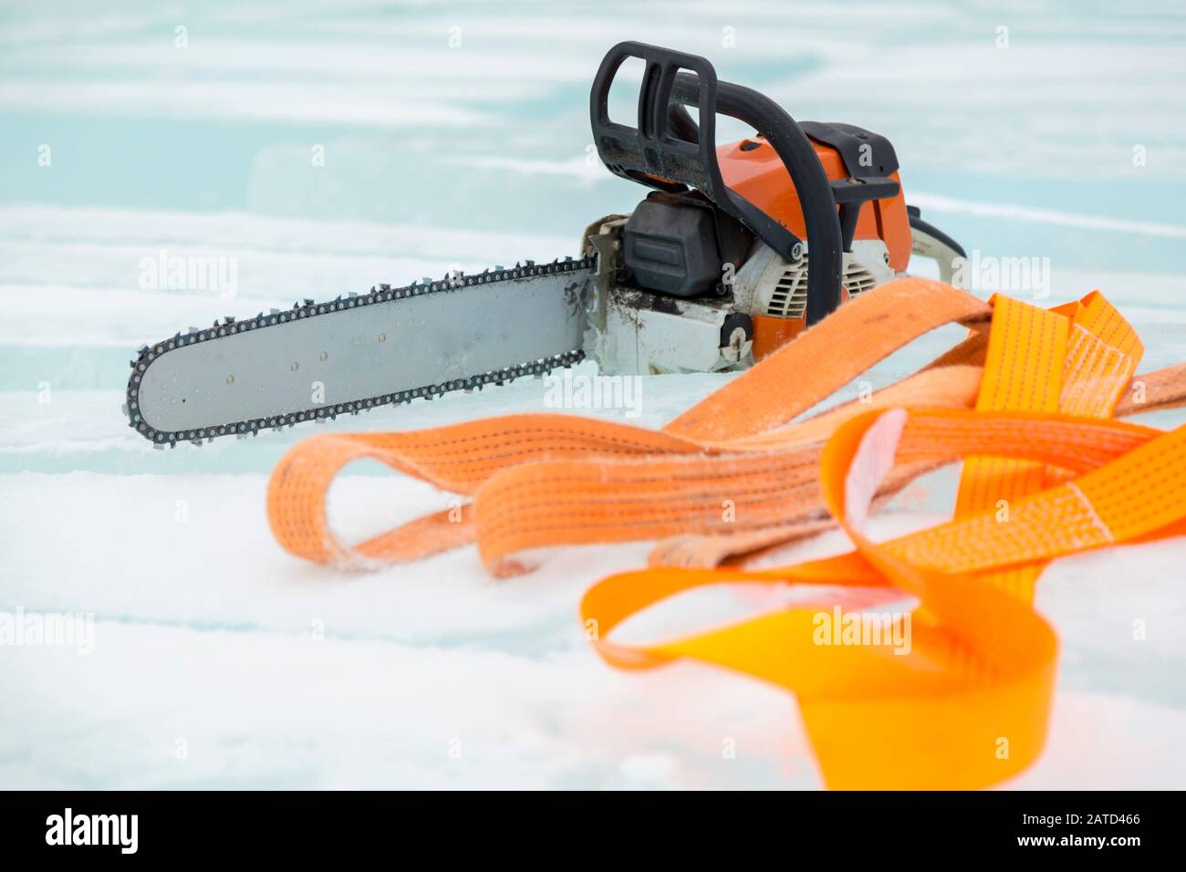 Motosega e nastro arancione imbragare su ghiaccio Foto stock - Alamy
