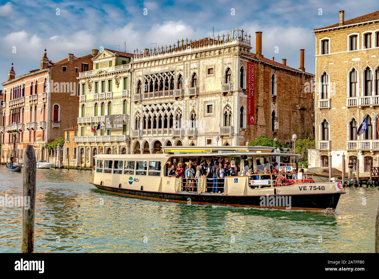 Un percorso 2 Vaporetto occupato da passeggeri, passando per la Ca' d'Oro, un palazzo gotico veneziano sul Canal Grande, nel quartiere Cannaregio, Venezia Italia Foto Stock
