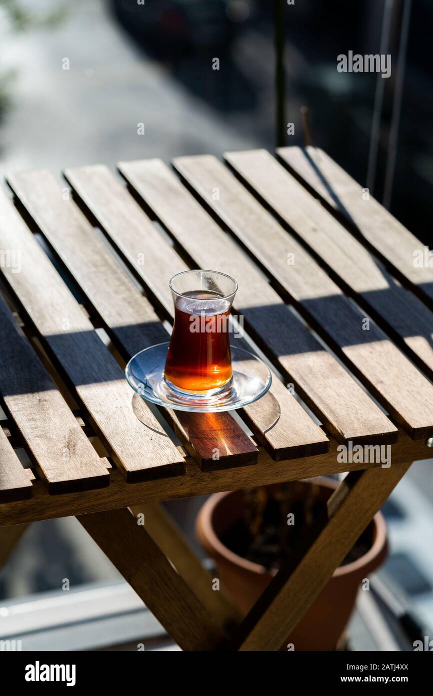 Tradizionale tè turco al balcone di casa su tavolo di legno. Bevande Calde. Foto Stock