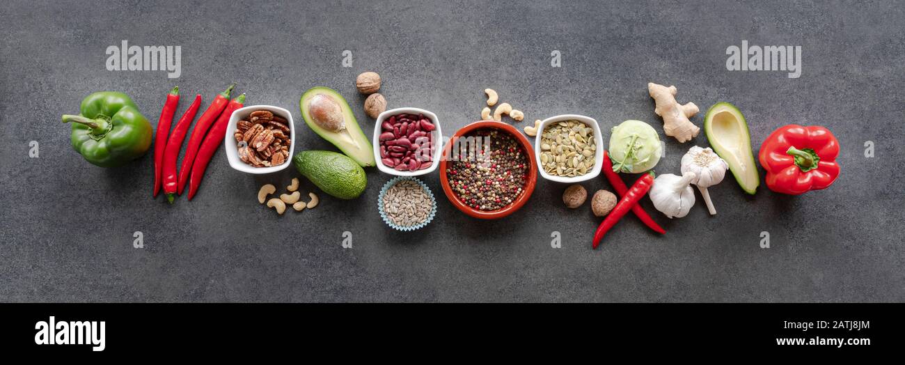 Cibo sano e pulito scelta alimentare: Verdure, semi, superfood, verdure in foglia su sfondo grigio cemento Foto Stock